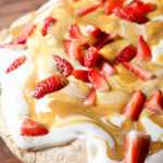 Pavlova with whipped cream, salted caramel and strawberries