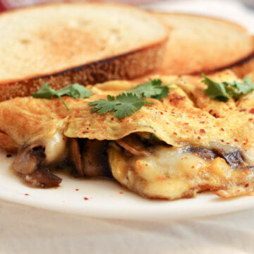 Make this stuffed mushroom and cheese omelette for breakfast and serve with tea and toasted bread. Or perhaps dinner with a light green salad on the side.