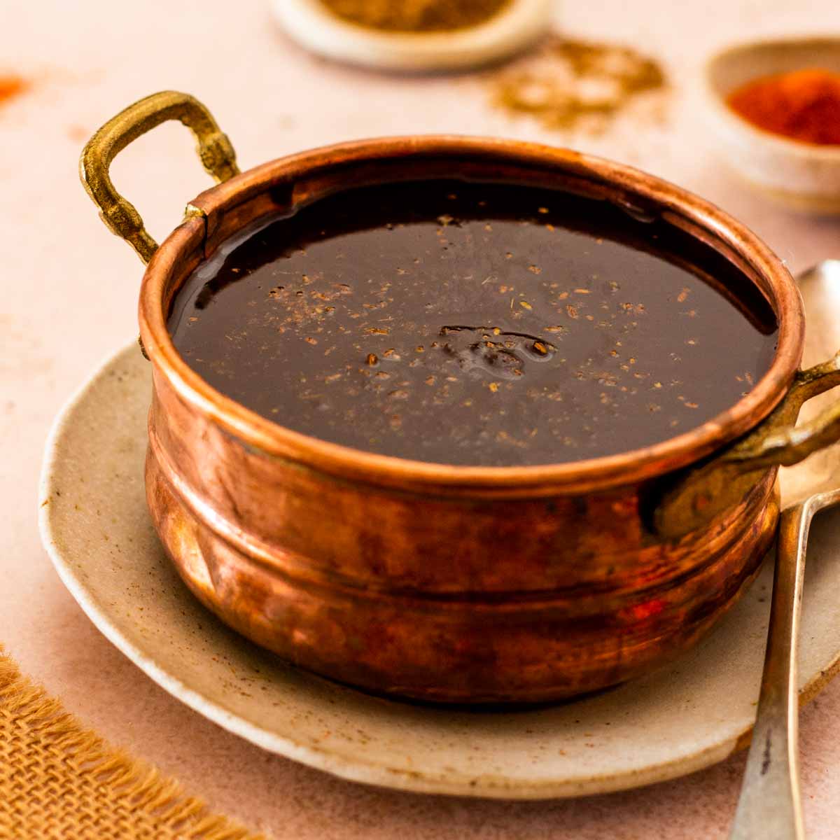 A golden bowl with imli or tamarind chutney.