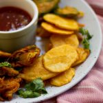 Similar to potato fritters, aloo pakora or aloo pakoda (in Hindi) are a traditional Pakistani / Indian appetizer of sliced potatoes that are coated with a spicy chickpea flour batter and  deep-fried till golden brown. 