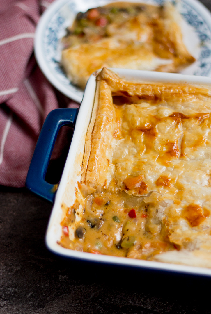 Chicken pot pie is comfort food personified. Chicken and vegetables in a rich and creamy white sauce with flaky puff pastry on top. Delicious!