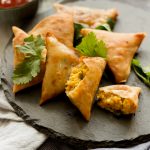 Chana dal samosas are a popular Pakistani & Indian vegetarian / vegan snack. Perfect for tea time with green chutney or raita on the side.  