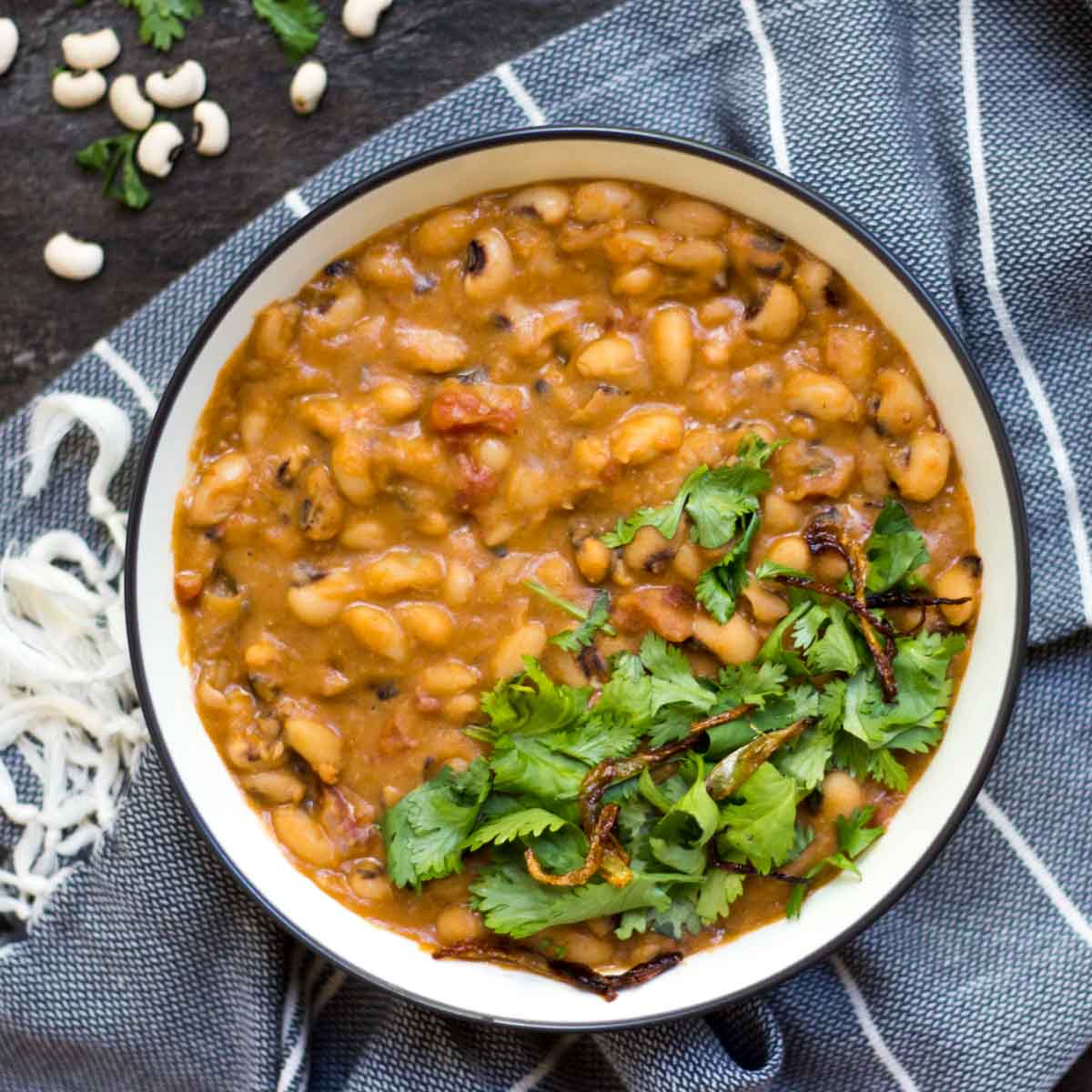 A bowl of lobia ka salan (black eyed peas curry) topped with coriander. 