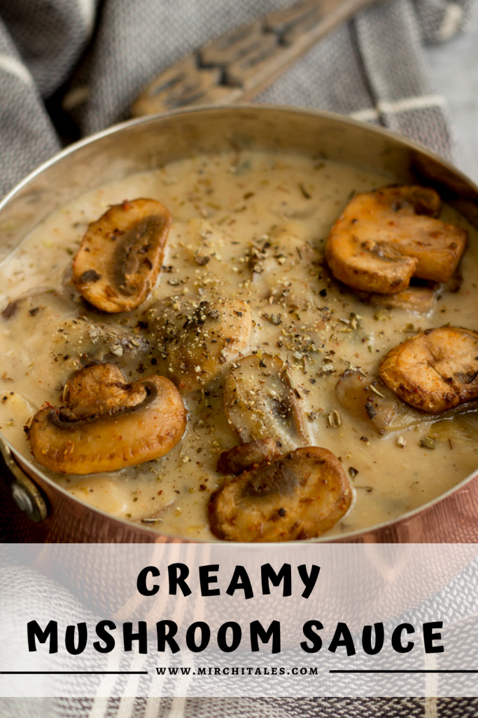 A copper coloured saucepan filled with mushroom sauce topped with five golden brown mushrooms, salt and black pepper. This copper saucepan is placed on top of a black and white striped napkin and on the top of image, the edge of a wooden spoon is peeking through. At the bottom of the image is text that says Creamy Mushroom Sauce followed by the website name www.mirchitales.com 