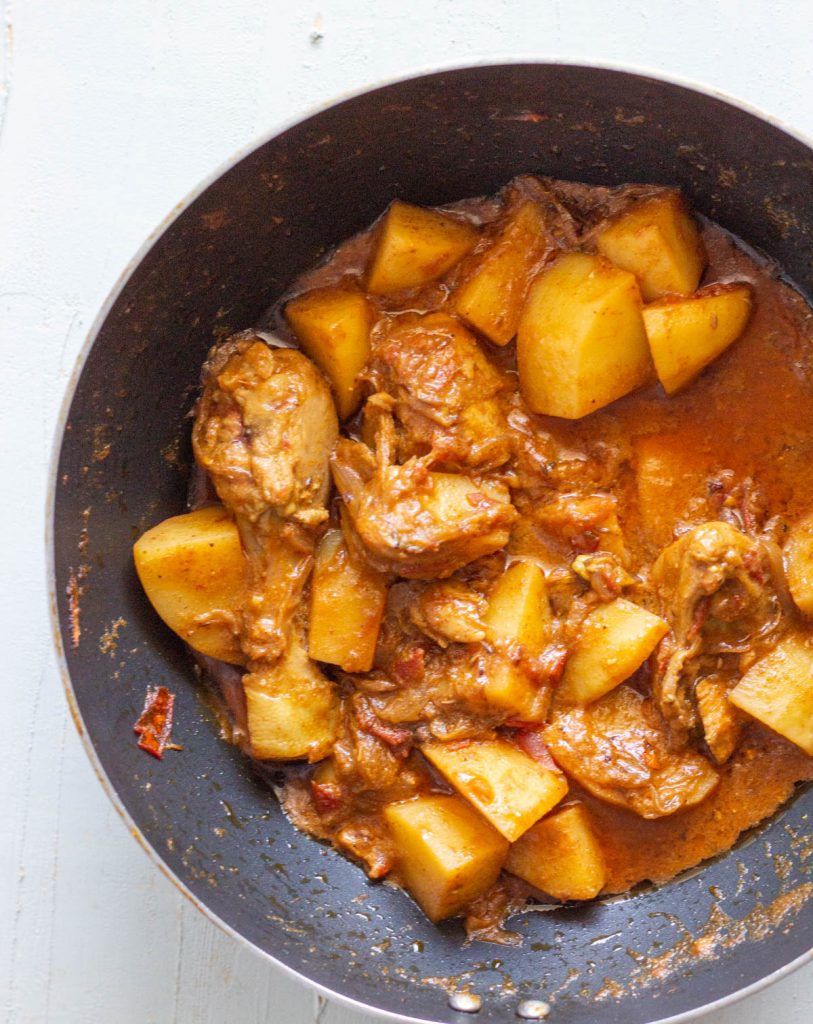 A wok filled with leftover chicken biryani masala.