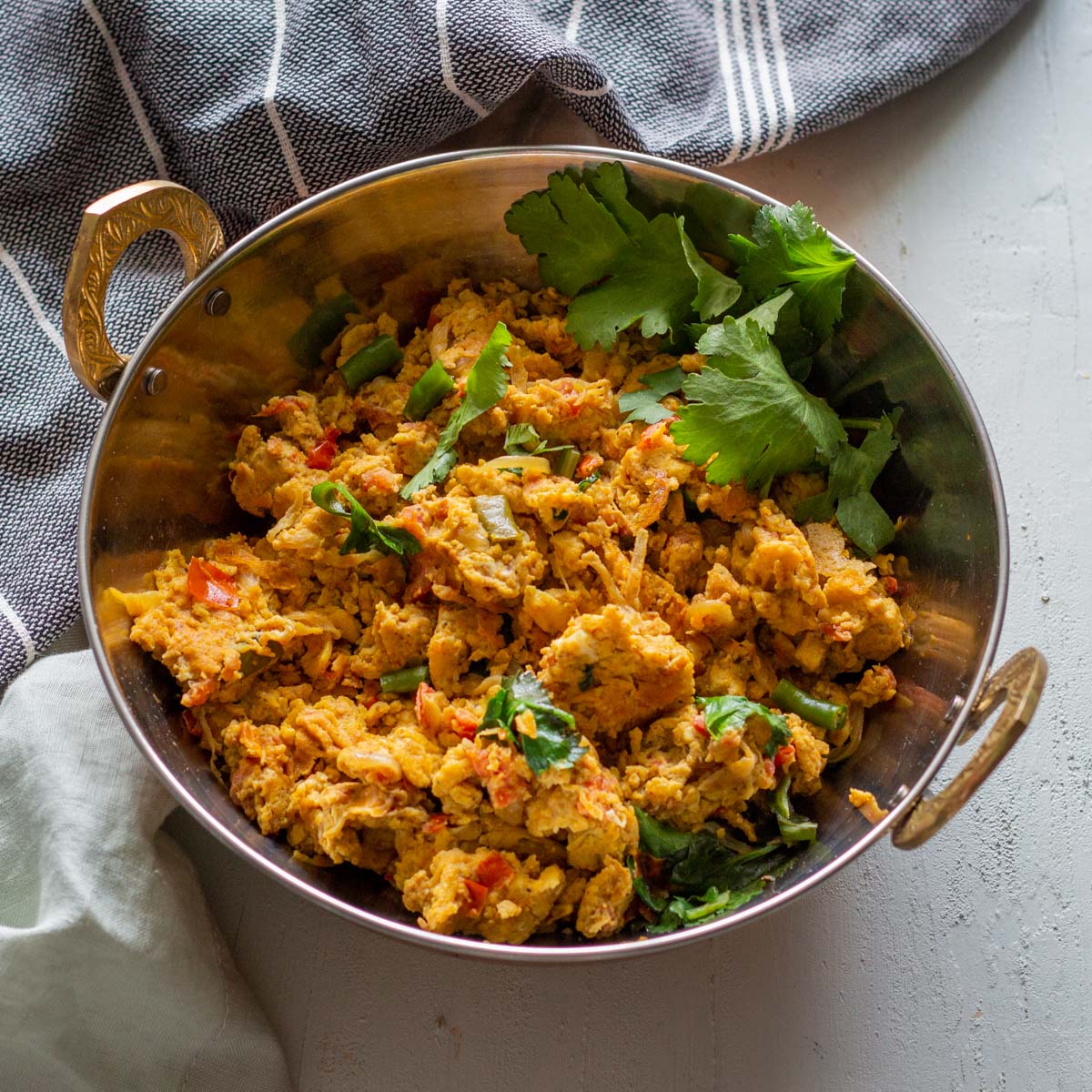 Khagina or Pakistani style scrambled eggs in a silver serving bowl.