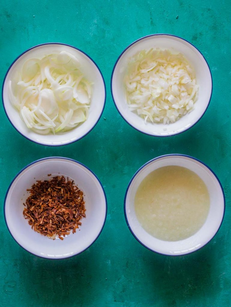 Four white bowls with blue rims. All bowls contain different types of onions. Clockwise from the top is are sliced onions, diced onions, onion paste and fried onions.