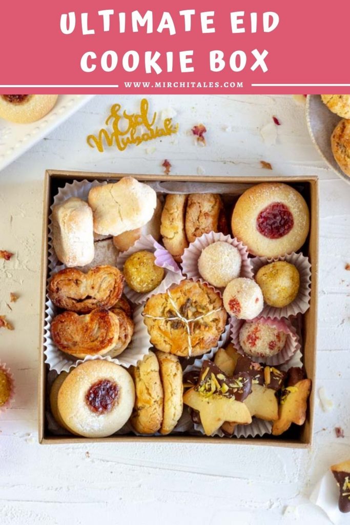 An Eid cookie box with an assortment of cookies. Clockwise from top left are Italian almond cookies, nan khatai, thumbprint jam cookies, coconut laddo, cardamom shortbread cookies with dark chocolate and pistachio, nan khatai and cinnamon palmers with nuts.