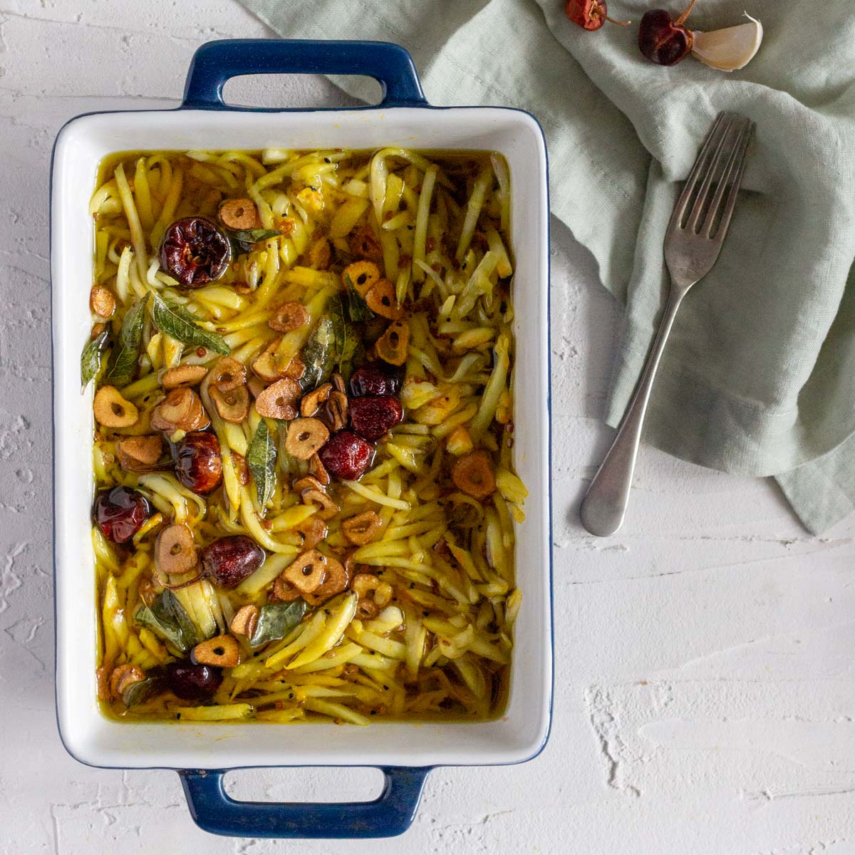 A blue dish filled with grated mango pickle or rishte ka achar.