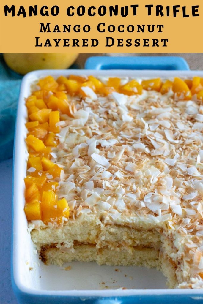 Mango coconut trifle or mango coconut layered dessert in a blue dish. The bottom left of the dish has a piece of the trifle taken out.