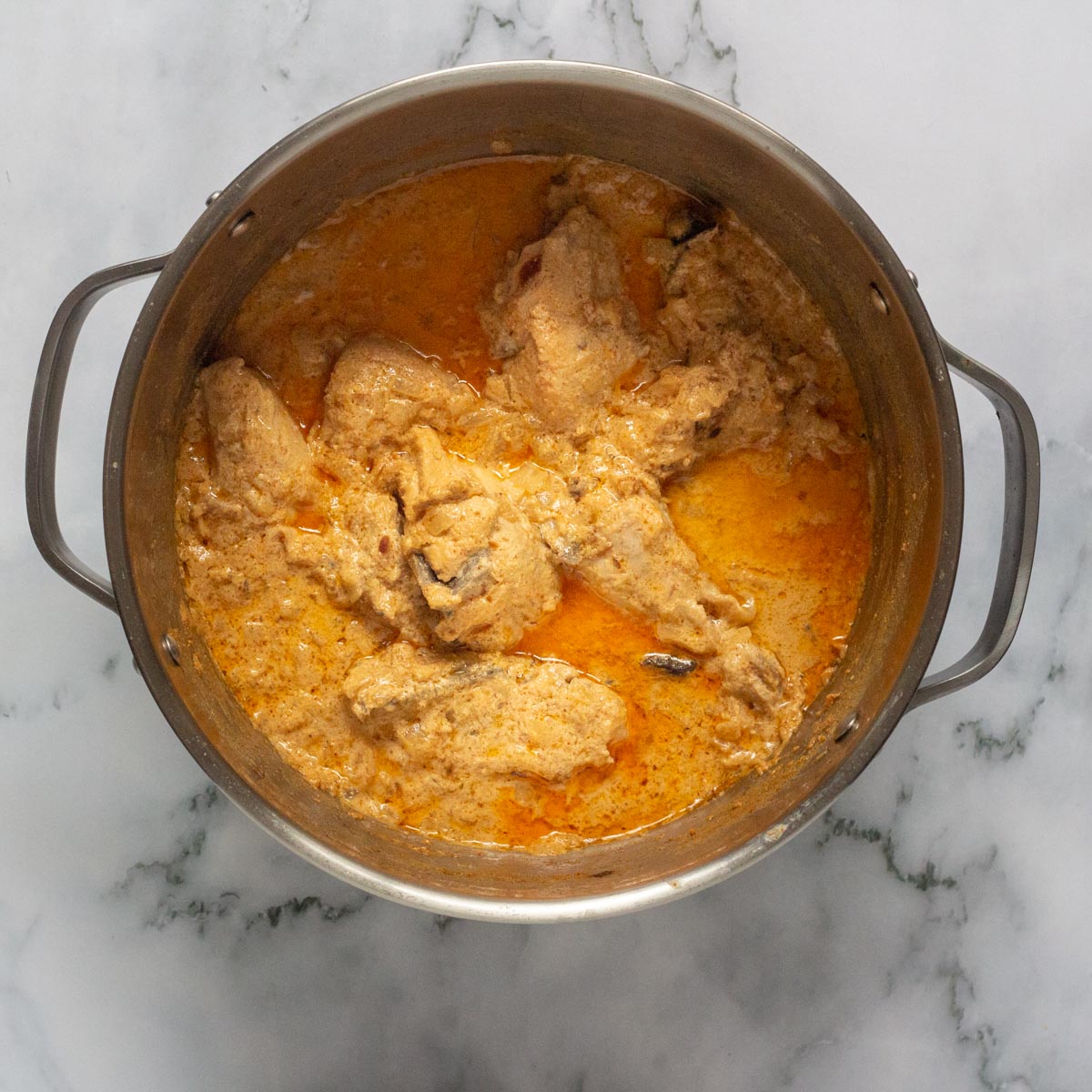 A bowl of chicken curry in a pot.